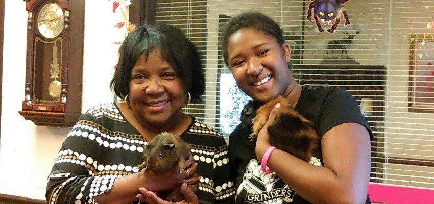 Etta McKenzie rescued a customer’s tiny family members after they suffered smoke inhalation in a fire. Belgium, left, and Donovan, held by owner Alyssa, were all thankful Etta took the guinea pigs under her wing for the night.