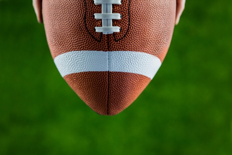 Close+up+view+of+upheld+football+on+american+football+field