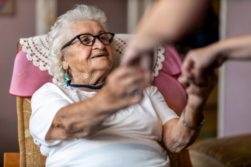 Older woman grip strength is tested Older woman grip strength is tested