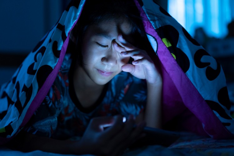 Child+with+Device+at+Night