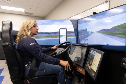 Ashley Leiva_Nov 2021 DMC Trucking Graduate_Simulator - U.S. Army veteran Ashley Leiva, a November 2021graduate of Del Mar College’s Transportation Training Services Program, demonstrates her driving skills using one of the simulators used to train DMC students earning their Commercial Drivers Licenses (CDLs). Program faculty nominated Leiva for the 2022 Transition Trucking: Driving for Excellence Award, and she is one of 11 and the only woman finalist out of thousands of veterans, national guard personnel and reservists. The winner will be announced by the U.S. Chamber of Commerce in Washington, D.C., on Dec. 16. (Credit: CRO Digital Services) Ashley Leiva_Nov 2021 DMC Trucking Graduate_Simulator