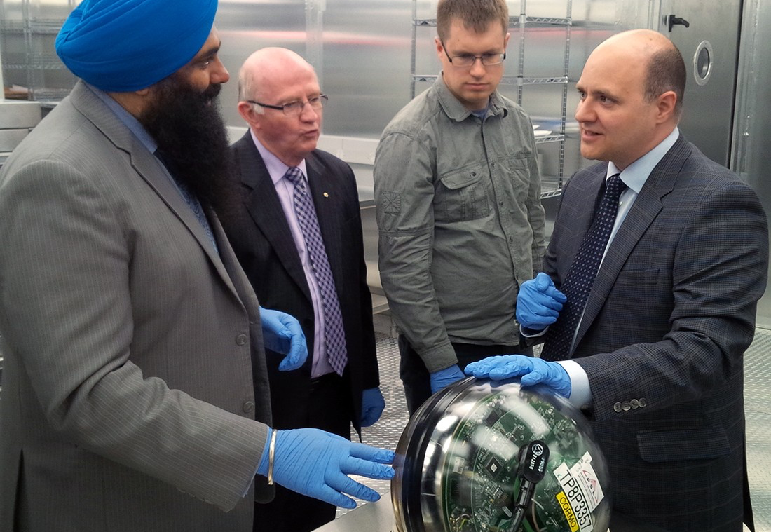 (From left) Minister Tim Uppal, U of A vice-president (research) Lorne Babiuk, and computing science professor Zachary Friggstad listen as Darren Grant demonstrates one of the IceCube digital optical modules during a tour of his astroparticle physics laboratory in the Centennial Centre for Interdisciplinary Science. (From left) Minister Tim Uppal, U of A vice-president (research) Lorne Babiuk, and computing science professor Zachary Friggstad listen as Darren Grant demonstrates one of the IceCube digital optical modules during a tour of his astroparticle physics laboratory in the Centennial Centre for Interdisciplinary Science.