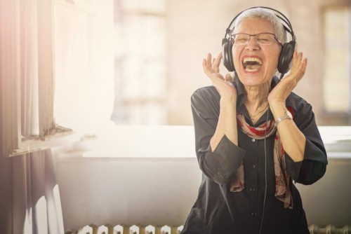 aging gracefully - Senior old woman listening to her favourite music through big headphones, enjoying the rich sound; Shutterstock ID 645178774; PO: .; Job: .; Client: .; Other: . aging gracefully