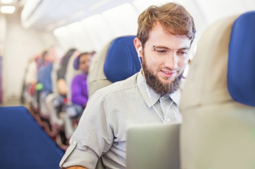 Guy travelling - Man using laptop on board of aircraft; Shutterstock ID 277564052 Guy travelling