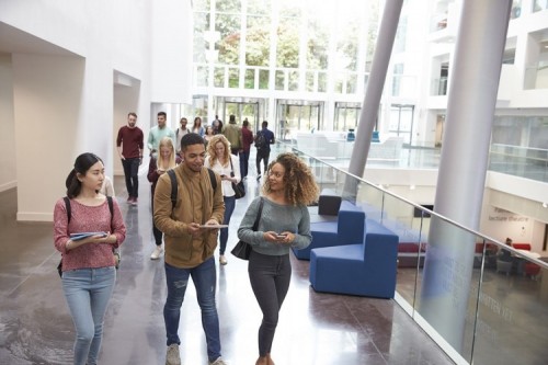 Study abroad - Students walk and talk using mobile devices in university; Shutterstock ID 478513852; PO: .; Job: .; Client: .; Other: . Study abroad