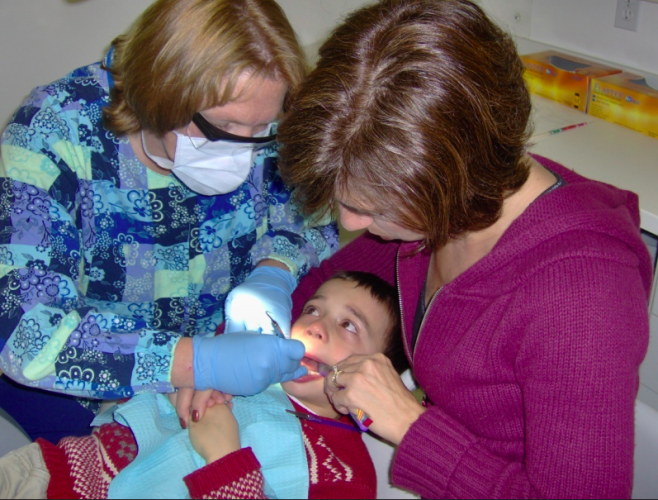 Karen Raposa and a friend provide treatment to her son, who at the age of 2 was diagnosed with autism spectrum disorder.