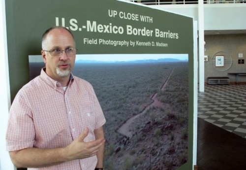 Kenneth Madsen, an Ohio State University Newark geography professor and border wall expert, discusses his photo exhibit of border wall pictures and maps. (AP Photo/Andrew Welsh-Huggins) Ohio State Professor Kenneth Madsen