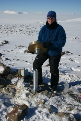 Terry Wilson assembling a GPS antenna on a monument fixed to the bedrock. This is at Westhaven Nunatak, Transantarctic Mountains. Terry Wilson