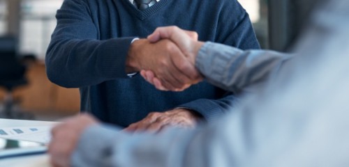 Compliance_Image - Shot of two businessmen shaking hands in an office Compliance_Image