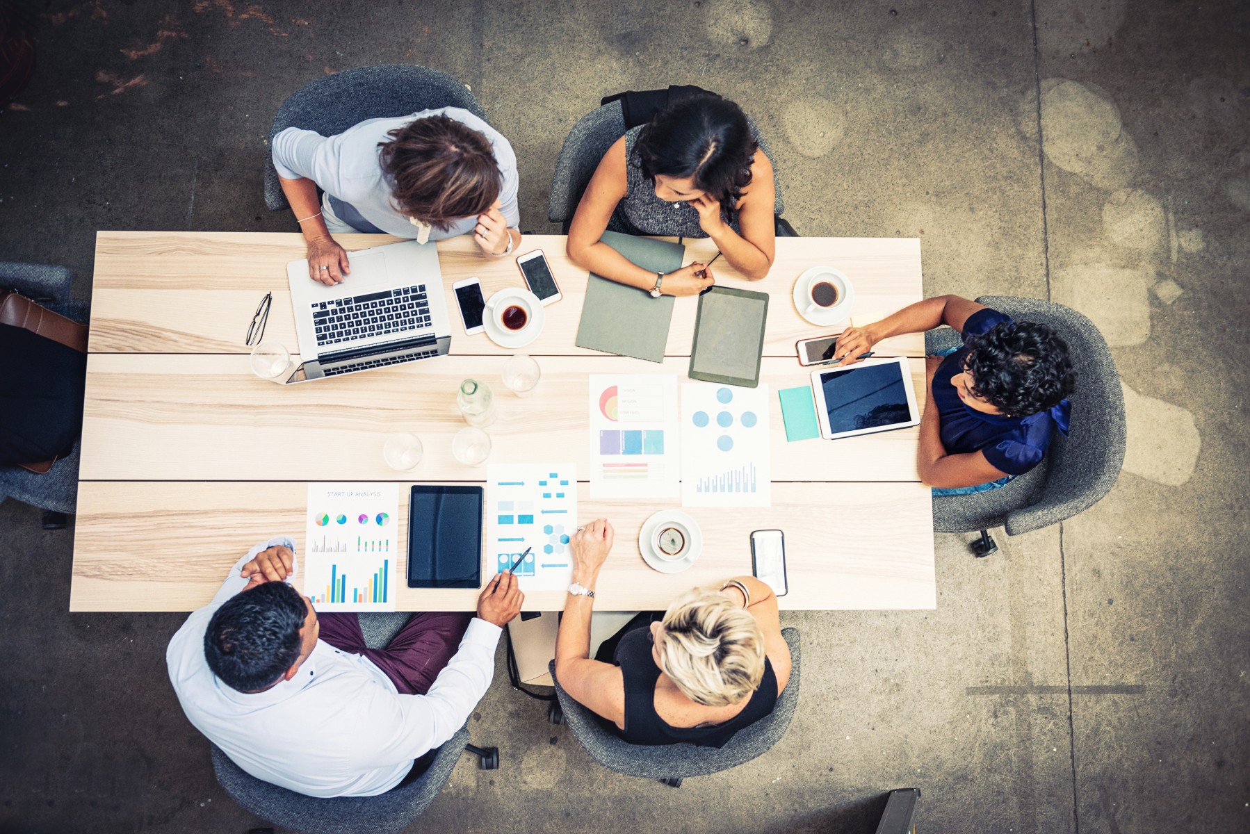Team working collaboratively at table - Team working collaboratively around table Team working collaboratively at table