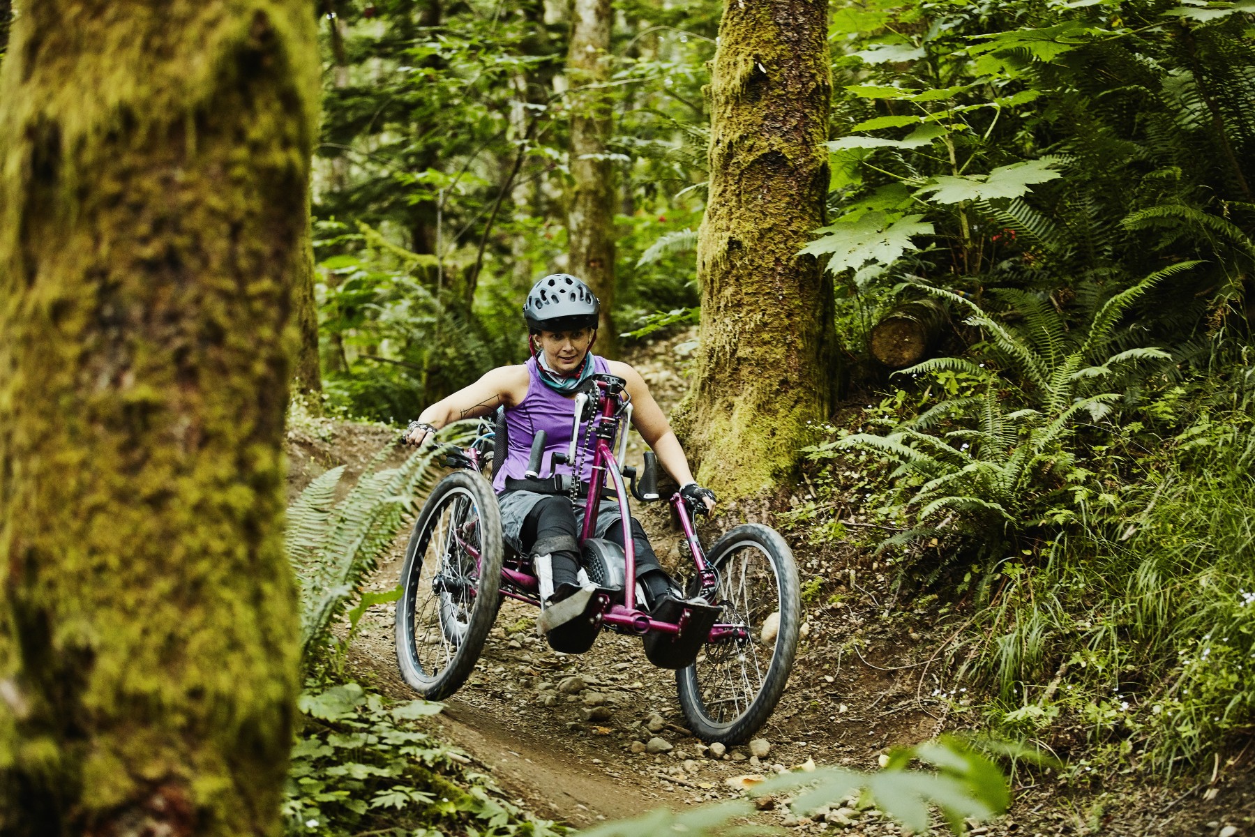 Sustainability 21 - Female wheelchair athlete descending trail on mountain bike Sustainability 21