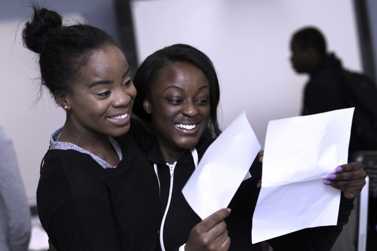 Elizabeth+Rafael%2C+18%2C+and+Keitro+Browy%2C+18%2C+of+Cardinal+Pole+school+celebrate+their+results