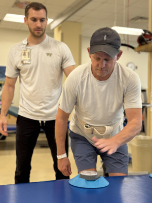 Mitch Parker works on balance, reach, and strength with his physical therapist Daniel Schaeffer, PT, DPT