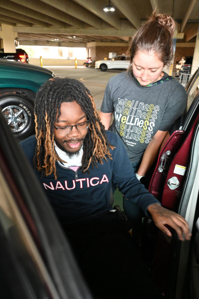 Tae Davis and Heather Jones strategize on transfers to an SUV.