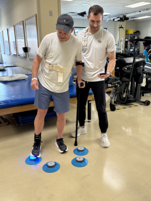 Mitch Parker tries to stomp out pod lights with his physical therapist Daniel Schaeffer, PT, DPT.