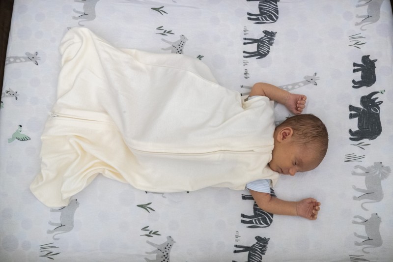 To keep your baby warm, use a sleep sack or long sleeved onesie.