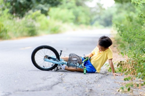 Boy Fall From The Bicycle During Ride On The Road
