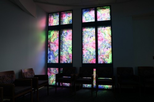 Glass windows with a colorful feature create a calming atmosphere.