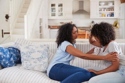 stock-photo-mother-talking-with-unhappy-teenage-daughter-on-sofa-715726975.jpg