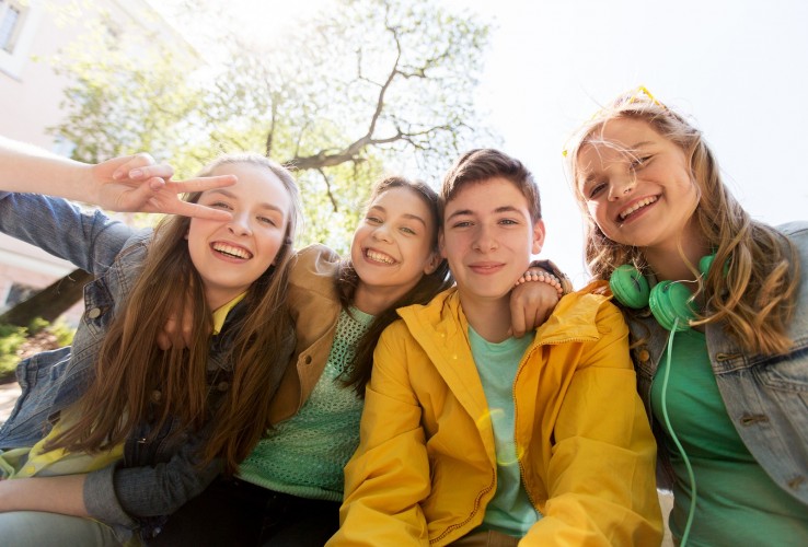 friendship and people concept - happy teenage friends or high school students having fun and making