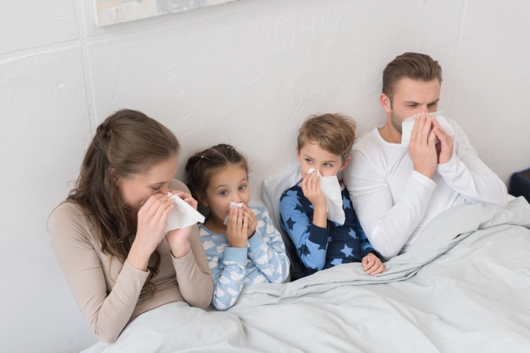 Family Blowing Noses In Napkins