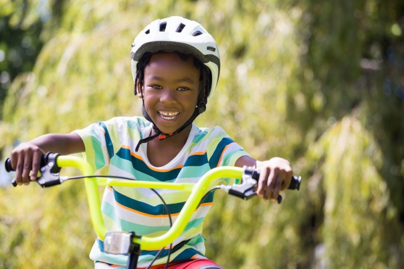stock-photo-a-sporty-kid-bike-riding-on-a-park-571374070.jpg