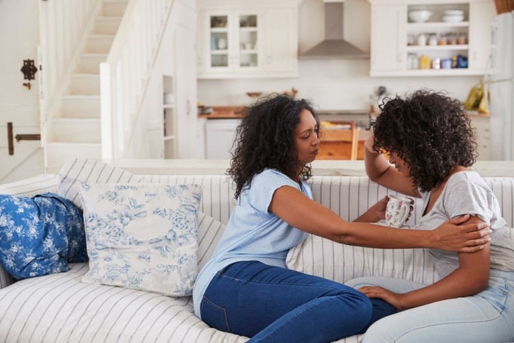 stock-photo-mother-talking-with-unhappy-teenage-daughter-on-sofa-715726975.jpg