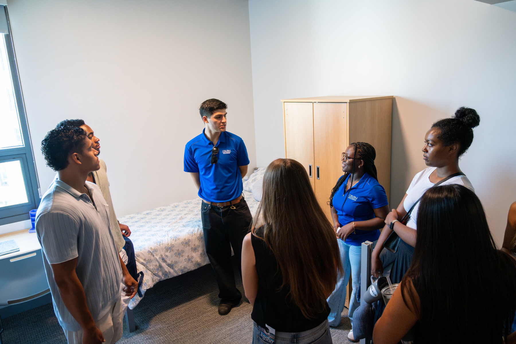 Student leaders give fellow students a tour of a room inside the new Black Oak Hall. Photo by Miguel Mota