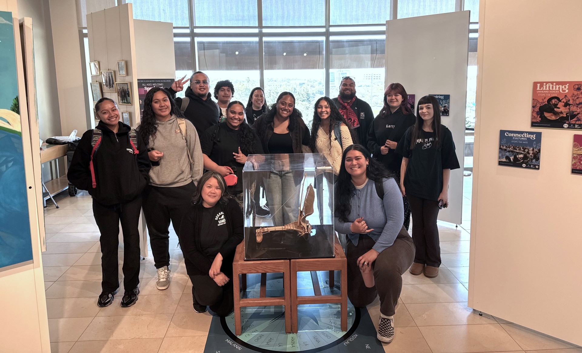 Group of people posing in the new library exhibit