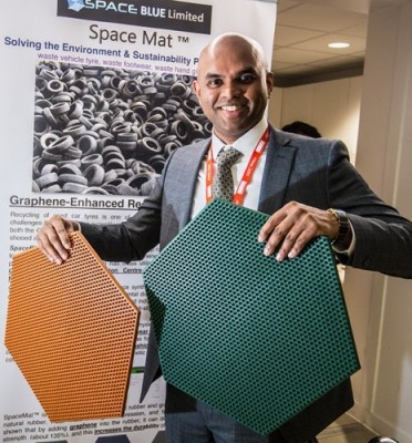 Dr Vivek Koncherry holding hexagonal version of his SpaceMat