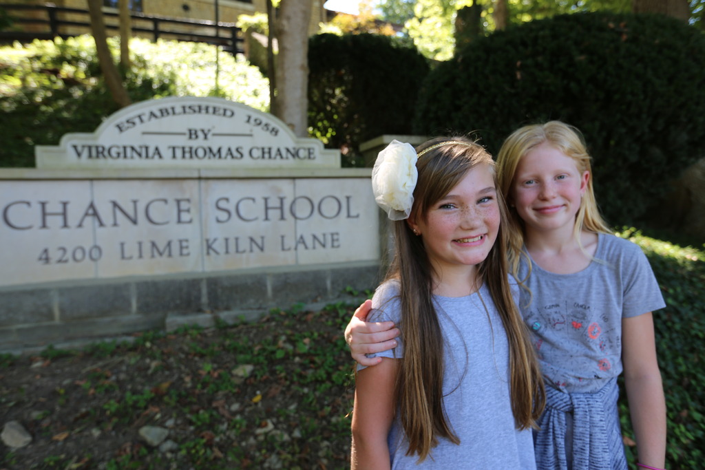 Two girls standing outside of Chance School
