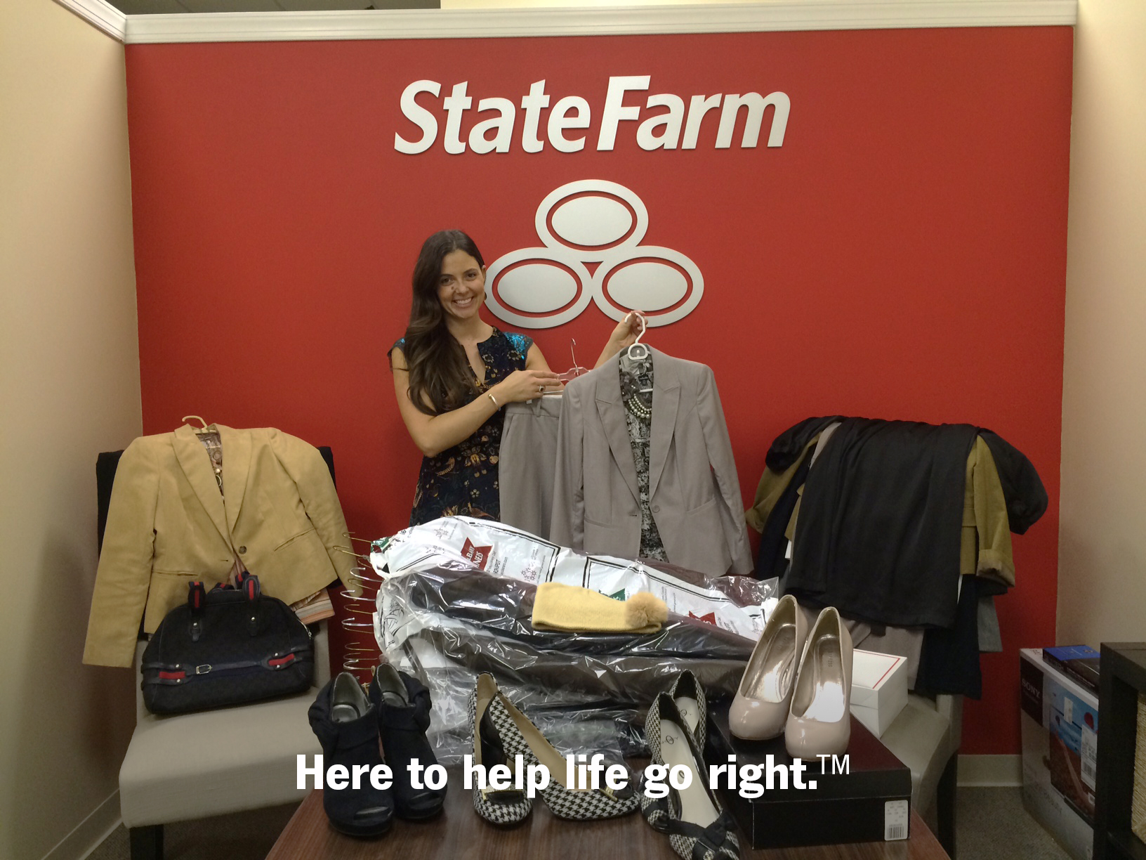 Andrea holding clothing donations