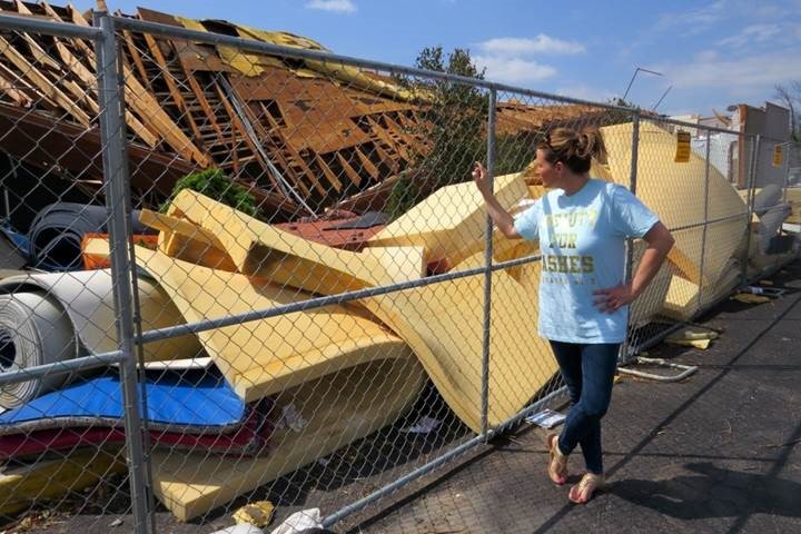 Jennifer Patterson viewing the remains of Aim High Academy's practice center following a tornado.