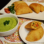empanadas and avocado sauce on a plate