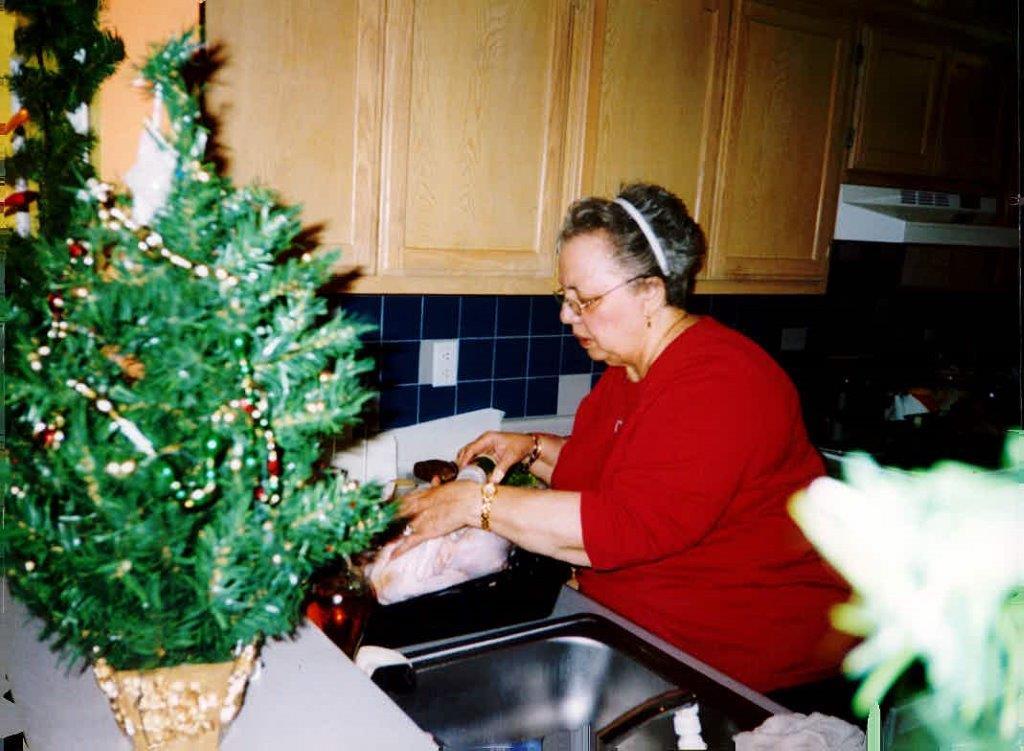 Alejandra's friend's grandmother cooking in the kitchen.