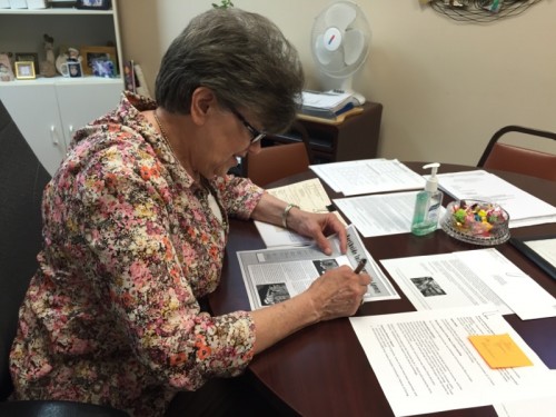 Connie working at her office table