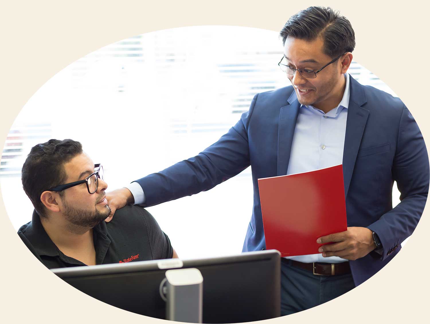 Photo of a two employees discussing the contents of a file