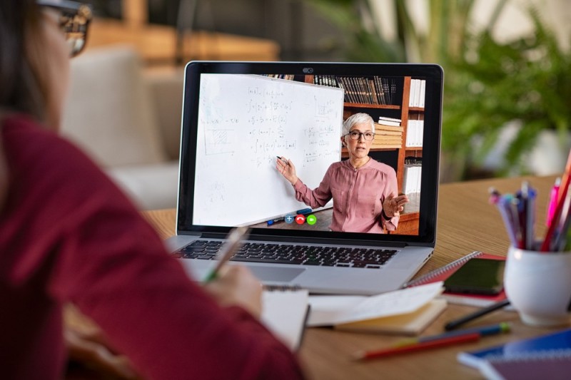 stock-photo-young-student-watching-lesson-online-and-studying-from-home-young-woman-taking-notes-while-looking-1676998306.jpg