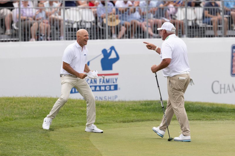 Crane and Clarke after winning putt on 18th