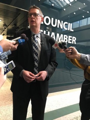 Senior Transportation Engineer Eric MacNaughton speaks with reporters following a Transportation & Transit standing policy committee meeting.