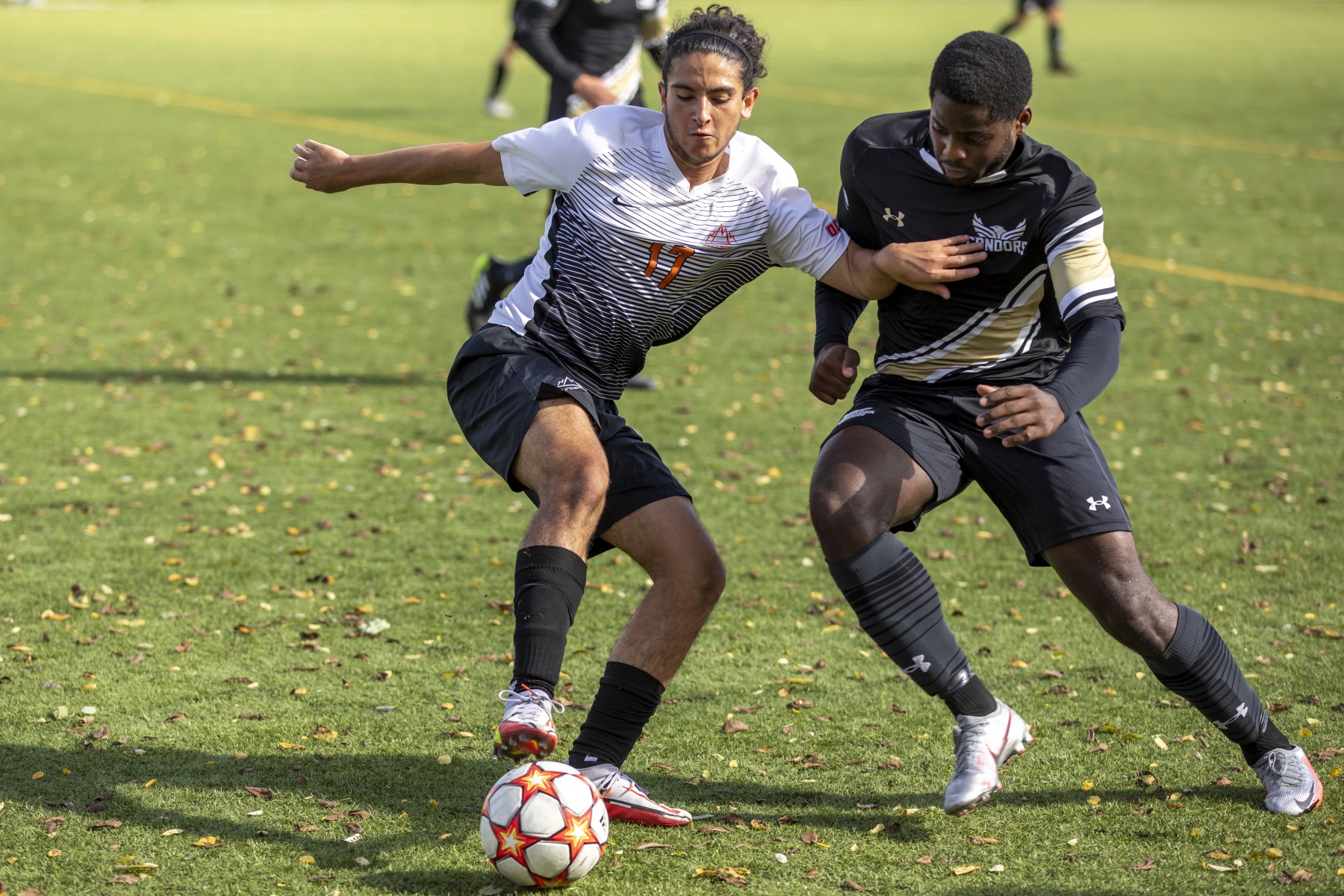 Mountaineer men's soccer athlete fighting to keep the ball in a game