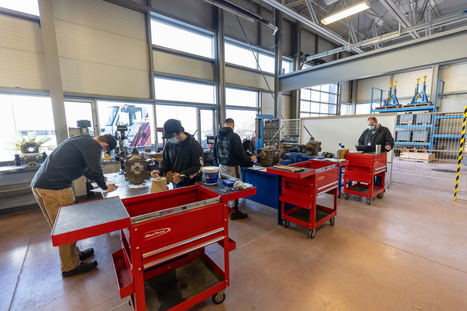 Truck and Coach program students working on parts in a class