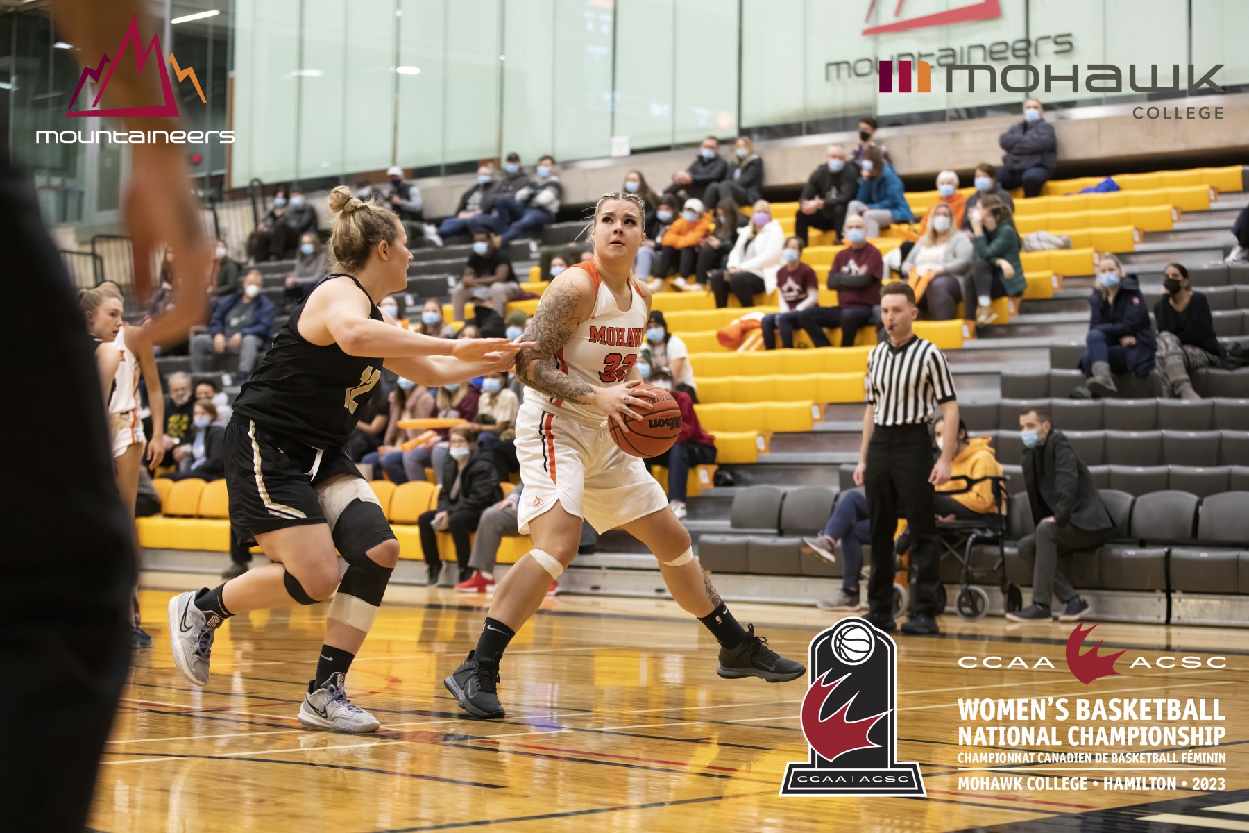 a female basketball player sets to jump, with a defender at her back (with logos of the CCAA Women's Basketball National Championship)