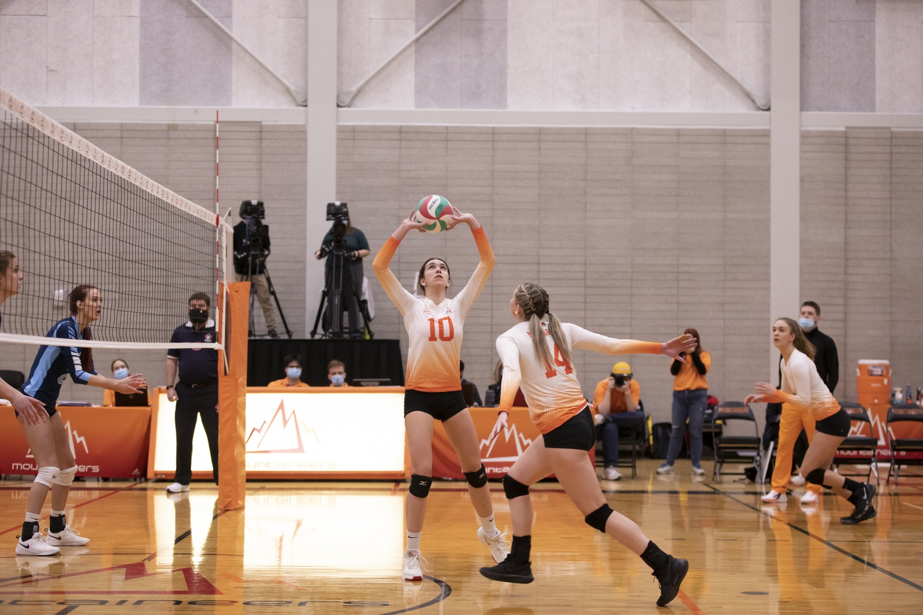 Mountain female volleyball  player sets a ball in a game