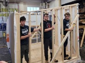 dual credit students nailing studs in a wall