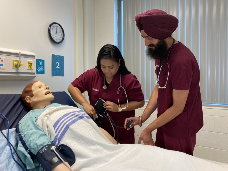 Students at Schlegel Villages in simulation lab with mannequin patient