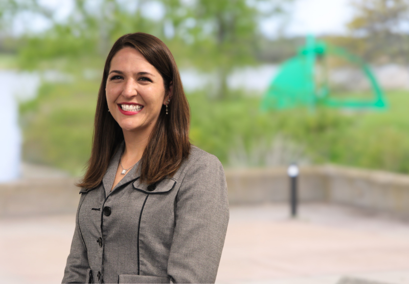 Portrait photo of a smiling woman outside on the Governors State University patio