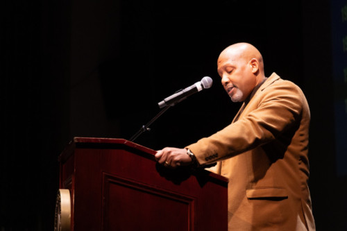 Sandy Womack speaking at a podium
