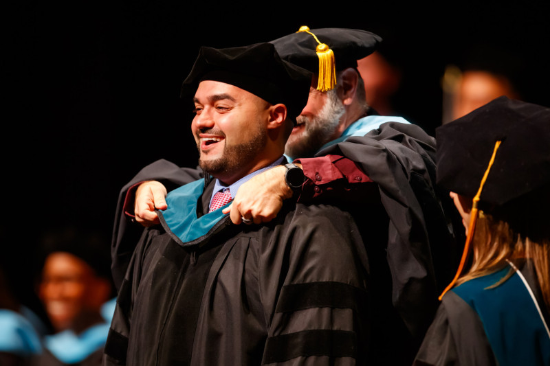 Daniel Pena in doctoral regalia at Governors State University Doctoral Hooding Ceremony