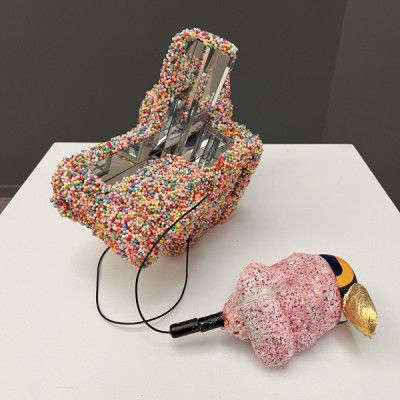 A sculpture by Stephen Williams that is covered in small rainbow colored spheres